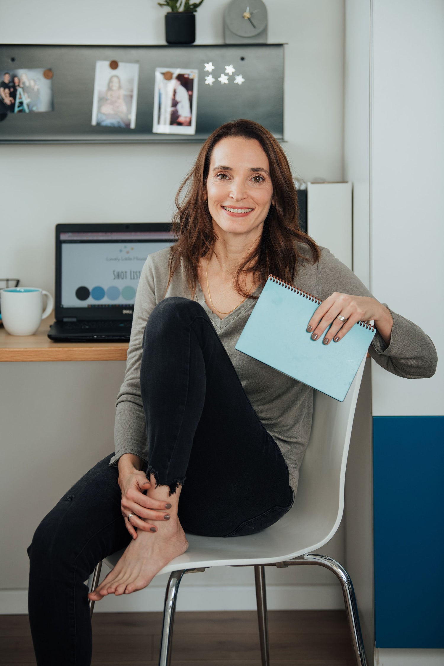 Adi Ben Zeev, the founder of Lovely Little House, sits smiling by her desk