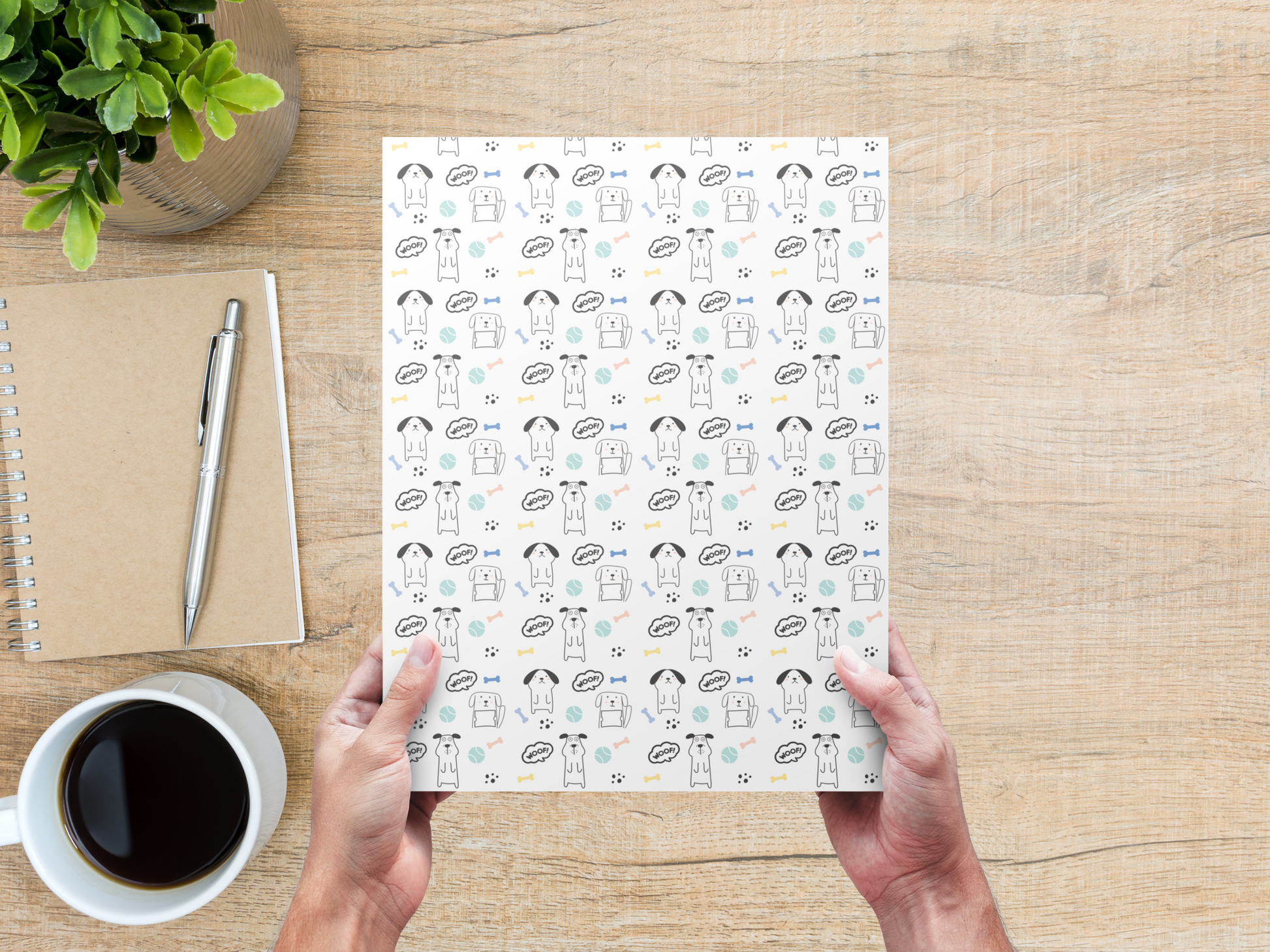 The dollhouse wallpaper pattern of cute puppies is held by a woman above a desk