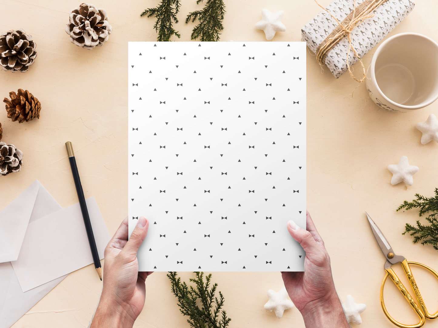 The dollhouse wallpaper pattern of Nordic style little black triangles is held by a woman above a desk
