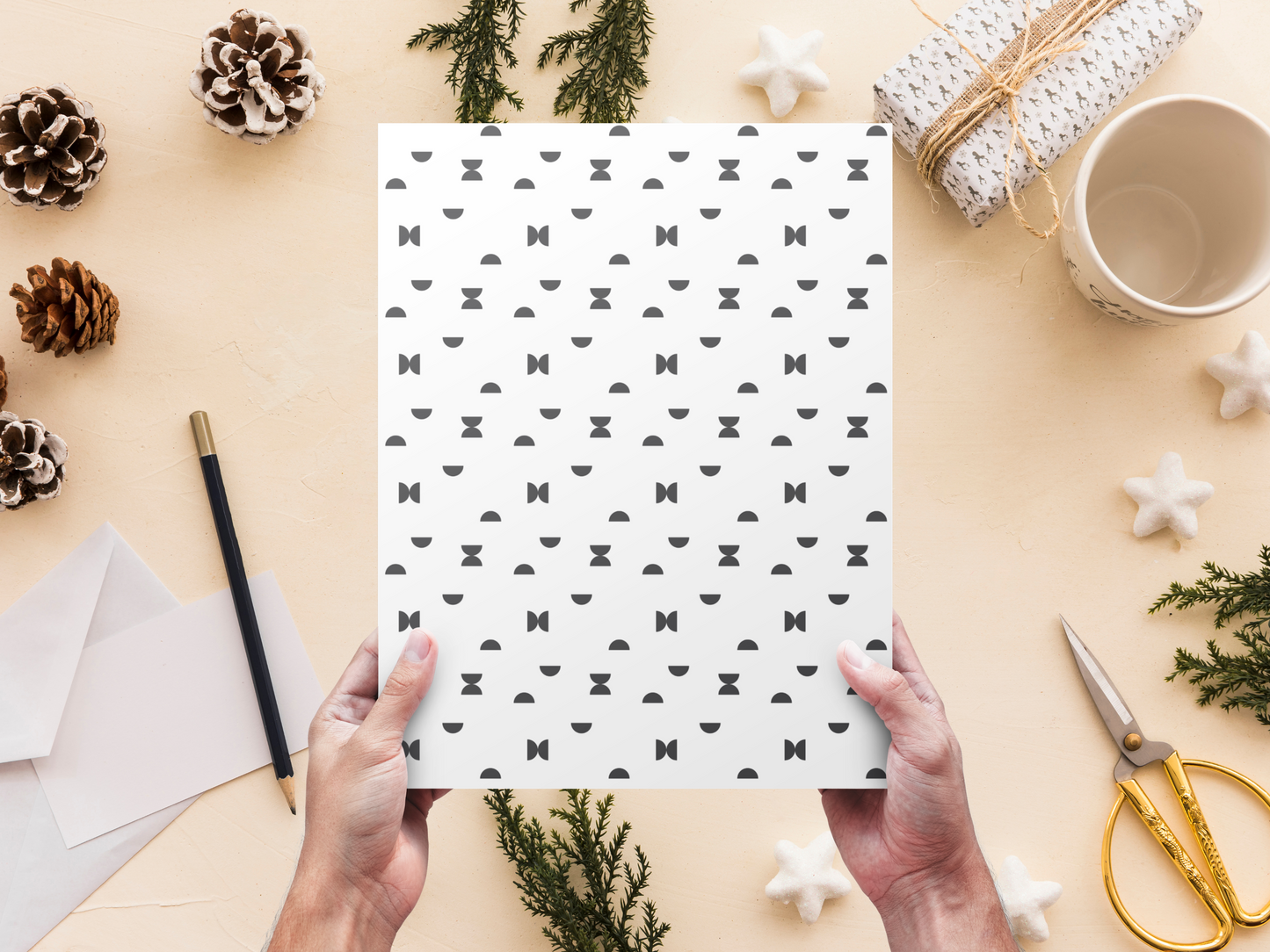 The dollhouse wallpaper pattern of Nordic style black semi circles is held by a woman above a desk