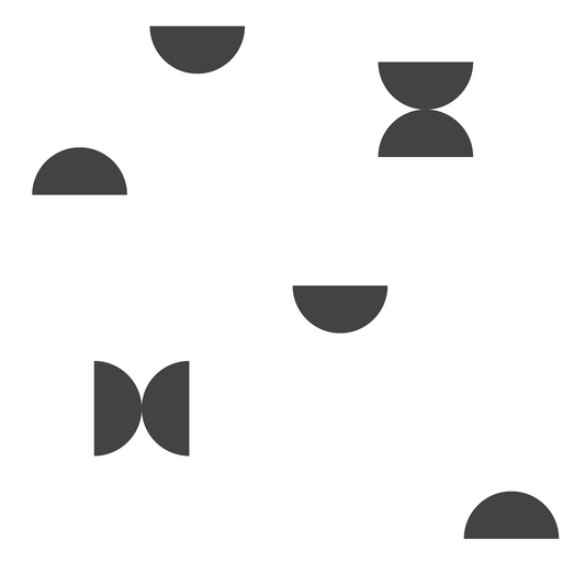 A closeup on a dollhouse wallpaper pattern of black semi circles