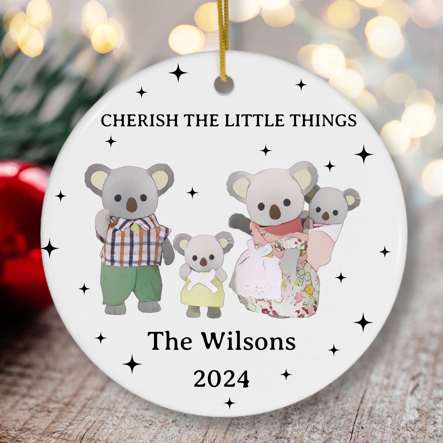 Decorative Christmas ornament with cartoon koalas and text 'Cherish the Little Things' on a white background.