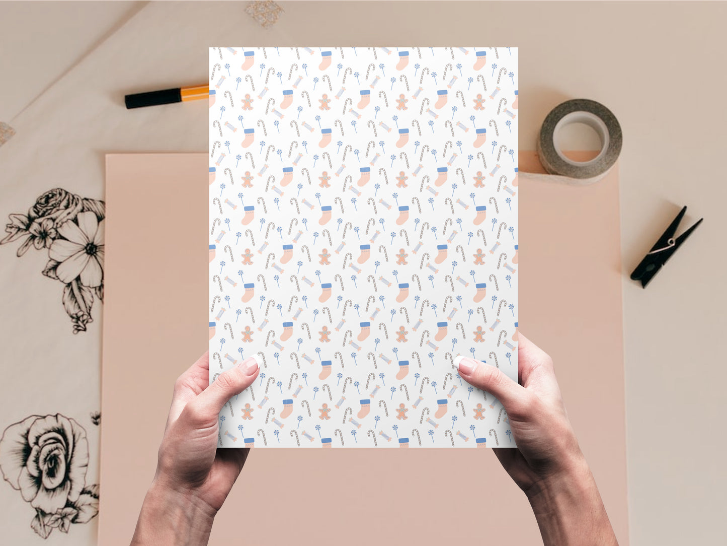 The Stockings and Candy dollhouse wallpaper is held by a woman above a desk