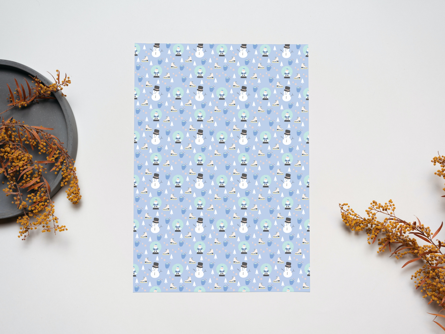 The Snowman and Snow Globe dollhouse wallpaper on a table near dry leaves