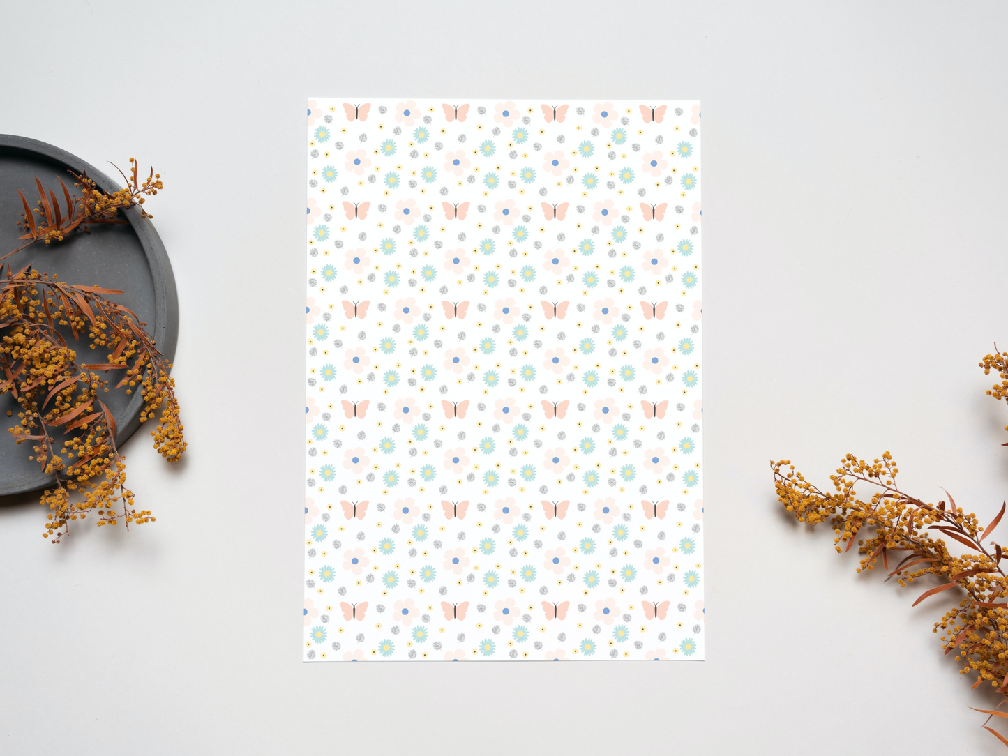 Cute pink butterflies and delightful blue daisies dollhouse wallpaper on a table near dry leaves