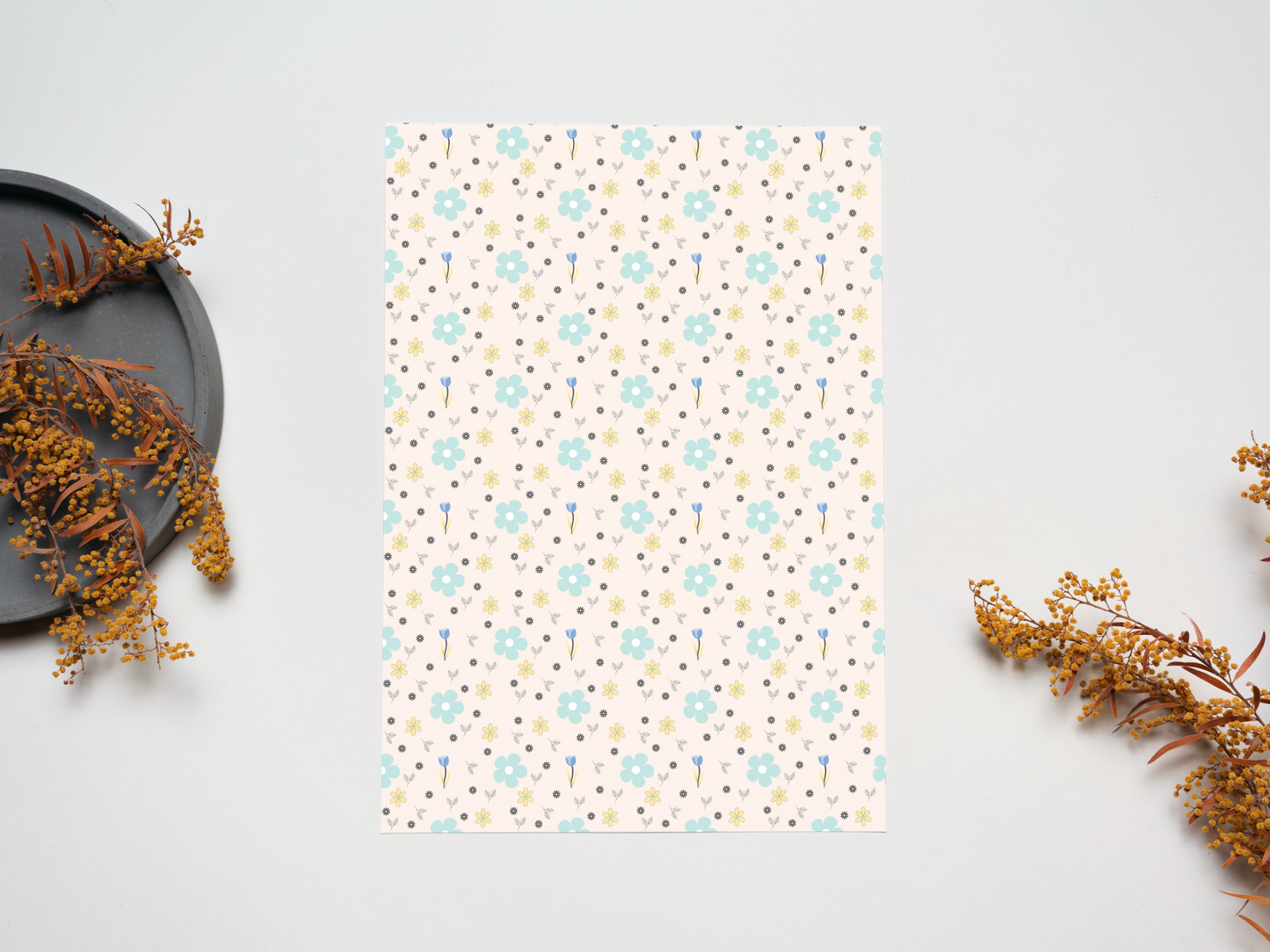 Flowers in Boho style dollhouse wallpaper on a table near dry leaves