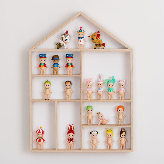 Front view closeup on a house-shaped wooden toy display shelf with Sonny Angels