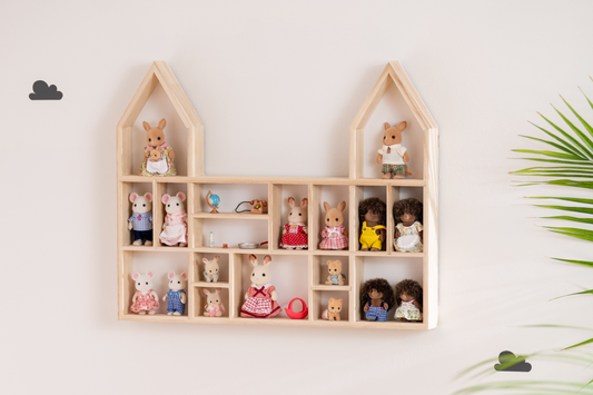 A castle display shelf showcasing Calico Critters figures and accessories