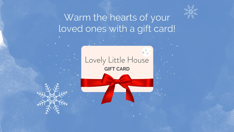 A gift card wrapped with a red ribbon under a blue snowy skies