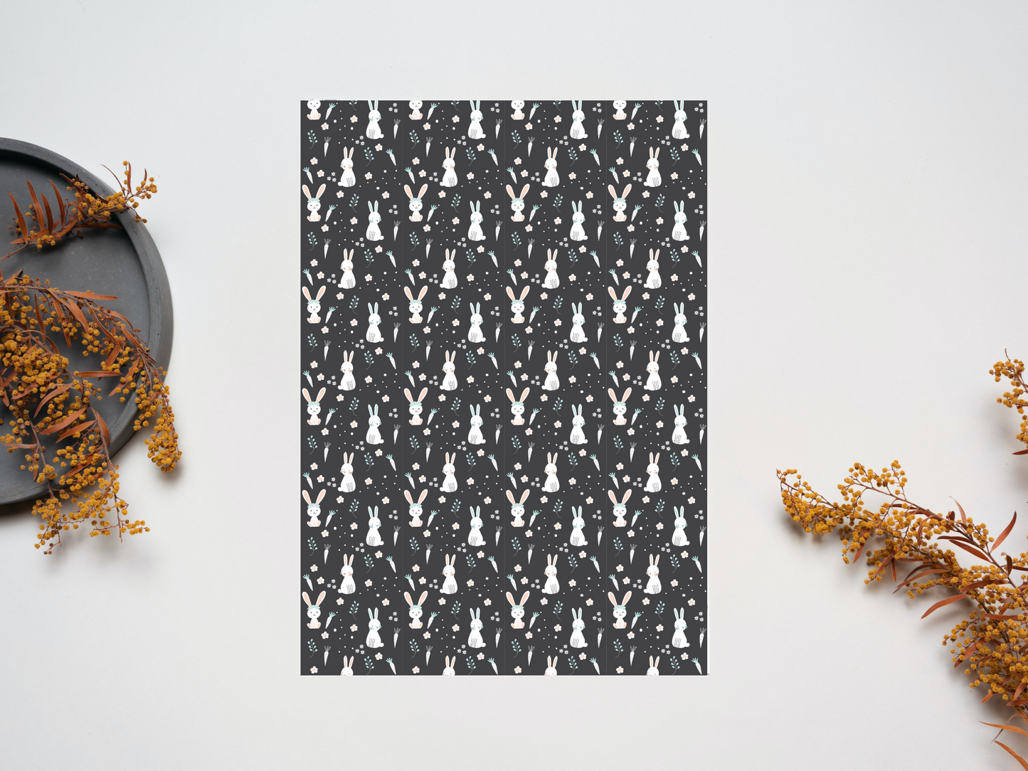 Cute bunnies dollhouse wallpaper on a table near dry leaves