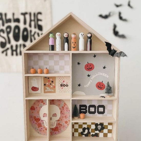 The house shaped shelf is shown in 3 different displays