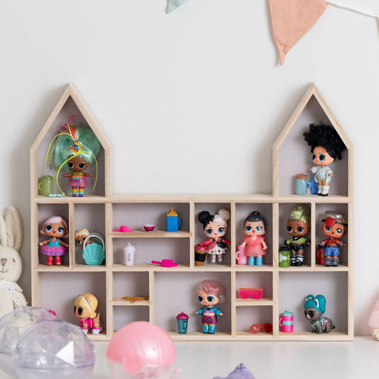 Closeup on a castle-shaped wooden toy display shelf with LOL dolls.