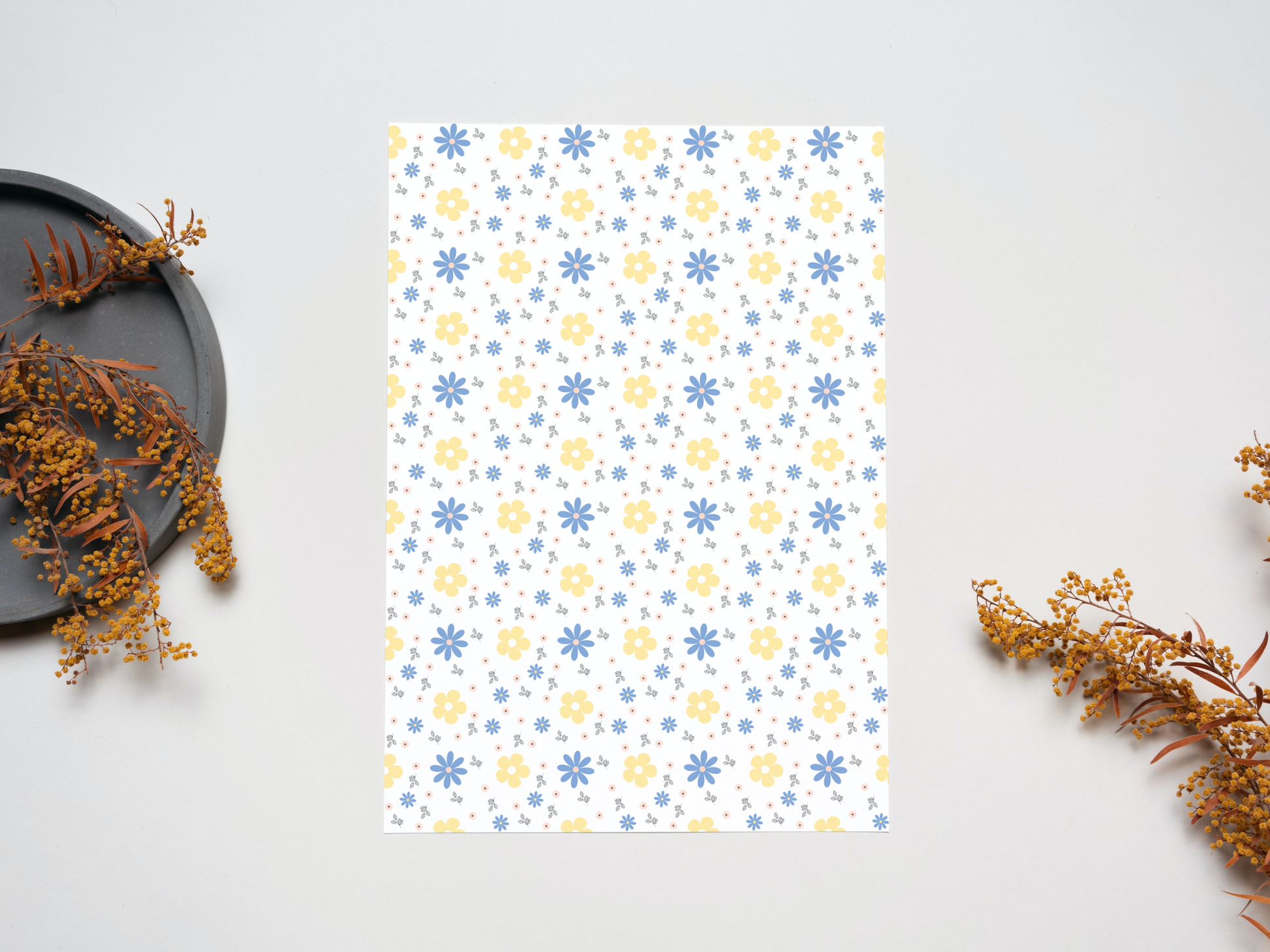 Blue and yellow flowers dollhouse wallpaper on a table near dry leaves